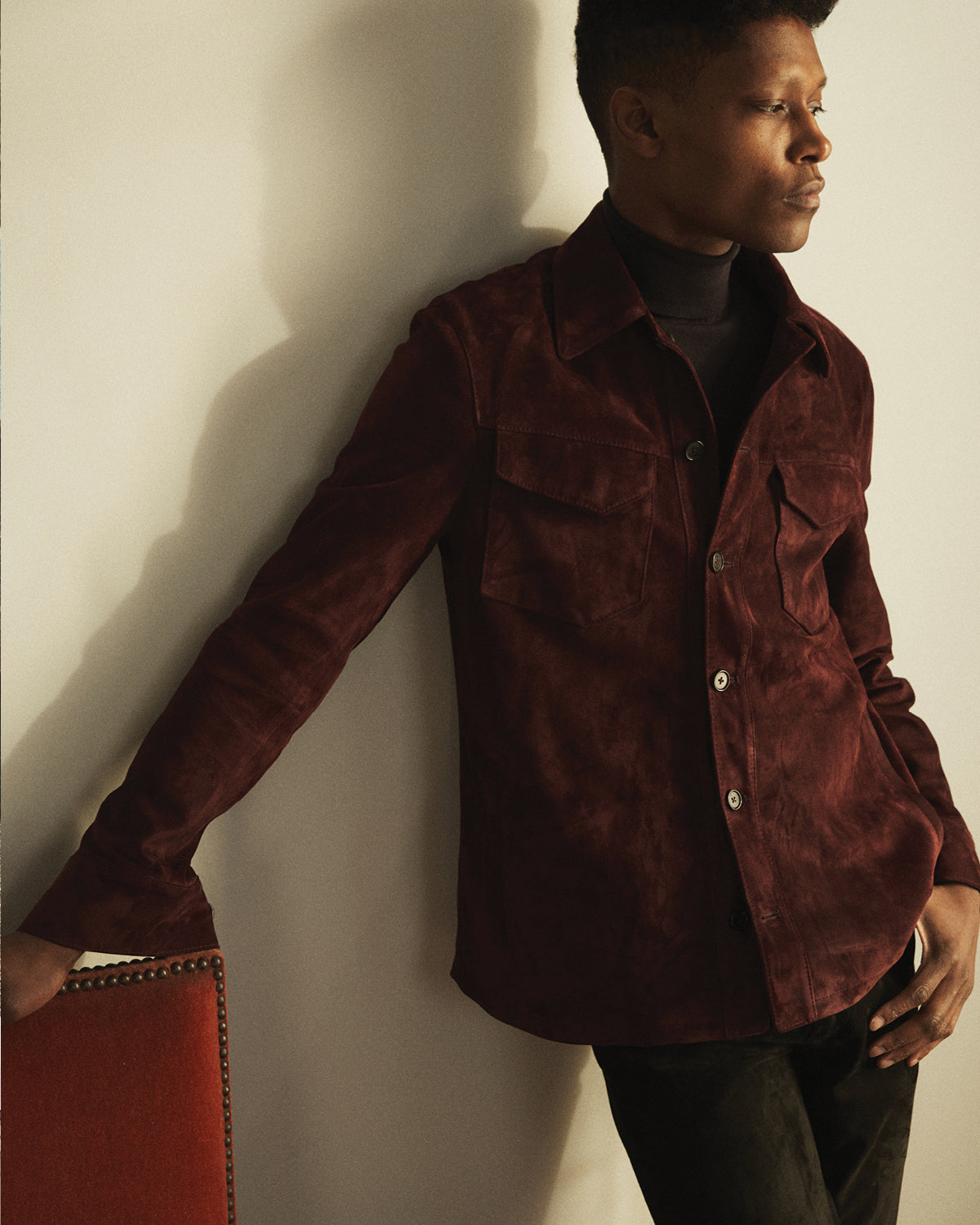 A man wearing a red suede Savas jacket